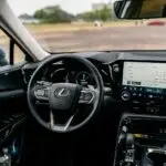 Detailed view of a Lexus car interior featuring a modern touchscreen and steering controls.
